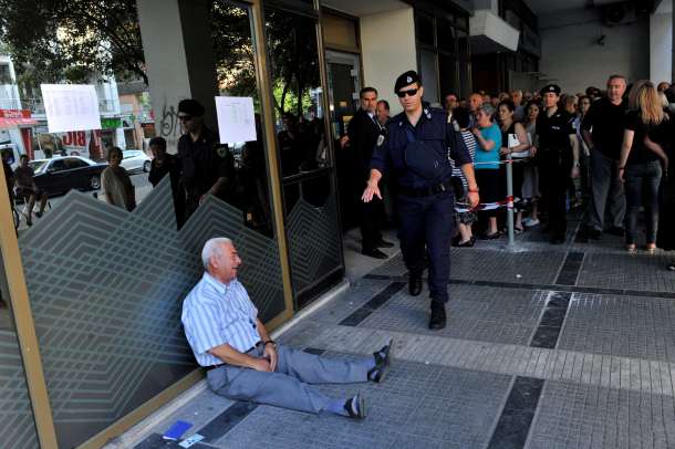 -- AFP PICTURES OF THE YEAR 2015 -- Giorgos Chatzifotiadis, an elderly man, cries outside a national bank branch in Thessaloniki on 3 July, 2015 as pensioners queue to draw their pensions, up to a limit of 120 euros. Greece is almost evenly split over a crucial weekend referendum that could decide its financial fate, with a 'Yes' result possibly ahead by a whisker, the latest survey Friday showed. Prime Minister Alexis Tsipras's government is asking Greece's voters to vote 'No' to a technically phrased question asking if they are willing to accept more tough austerity conditions from international creditors in exchange for bailout funds. AFP PHOTO /Sakis Mitrolidis