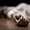 Dead woman's body with focus on hand