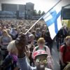 Mire Ibrahim waves the Finnish flag during a demonstration against racism where an estimated 15,000 people attended in Helsinki, Finland